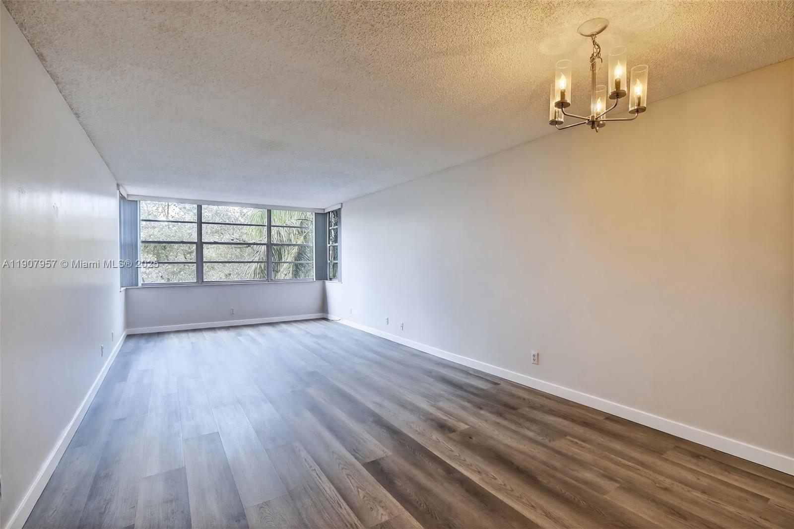 6500 Cypress Road, Unit 410 Plantation, FL 33317 - Photo 7 of 33 wooden floor in an empty room with a window