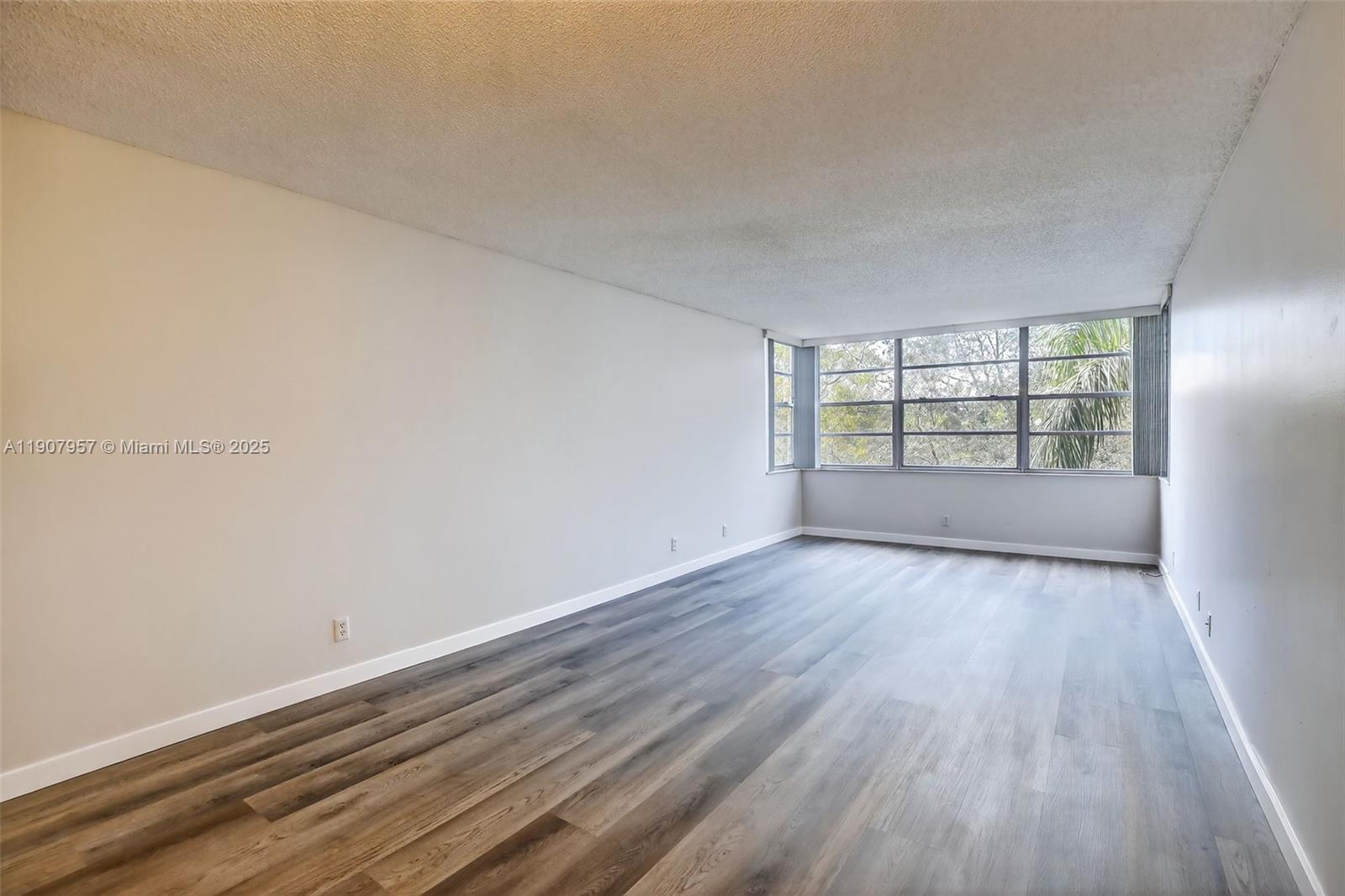 6500 Cypress Road, Unit 410 Plantation, FL 33317 - Photo 8 of 33 wooden floor in an empty room with a window