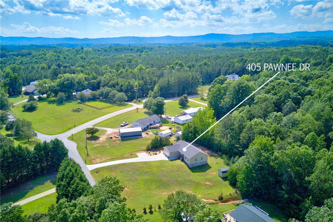 405 Pawnee Drive Walhalla, SC 29691 - Photo 31 of 36 Vast green acreage surrounds this tranquil residence, nestled within a lush, tree-lined landscape.