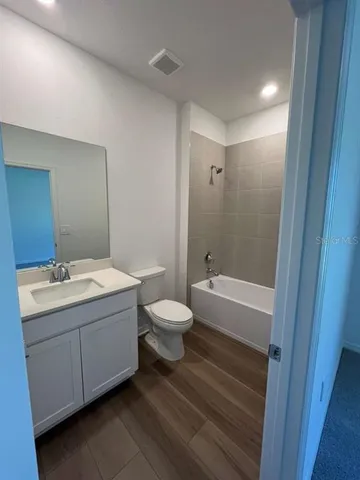 a bathroom with a toilet a sink and bathtub