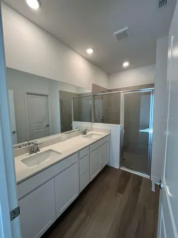 a bathroom with a double vanity sink and mirror