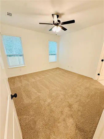 a view of a room with a ceiling fan