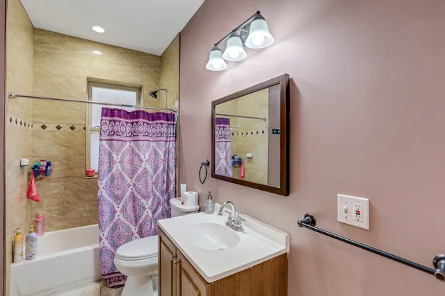 a bathroom with a sink mirror and a bathtub
