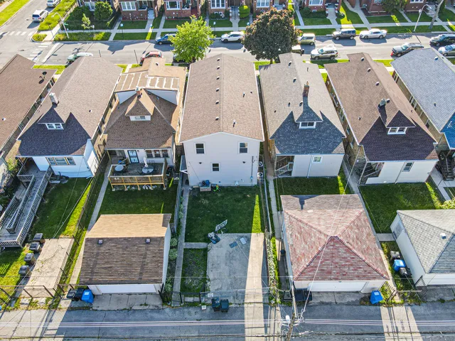 an aerial view of multiple houses with yard