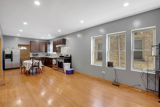 a kitchen with stainless steel appliances kitchen island granite top and refrigerator