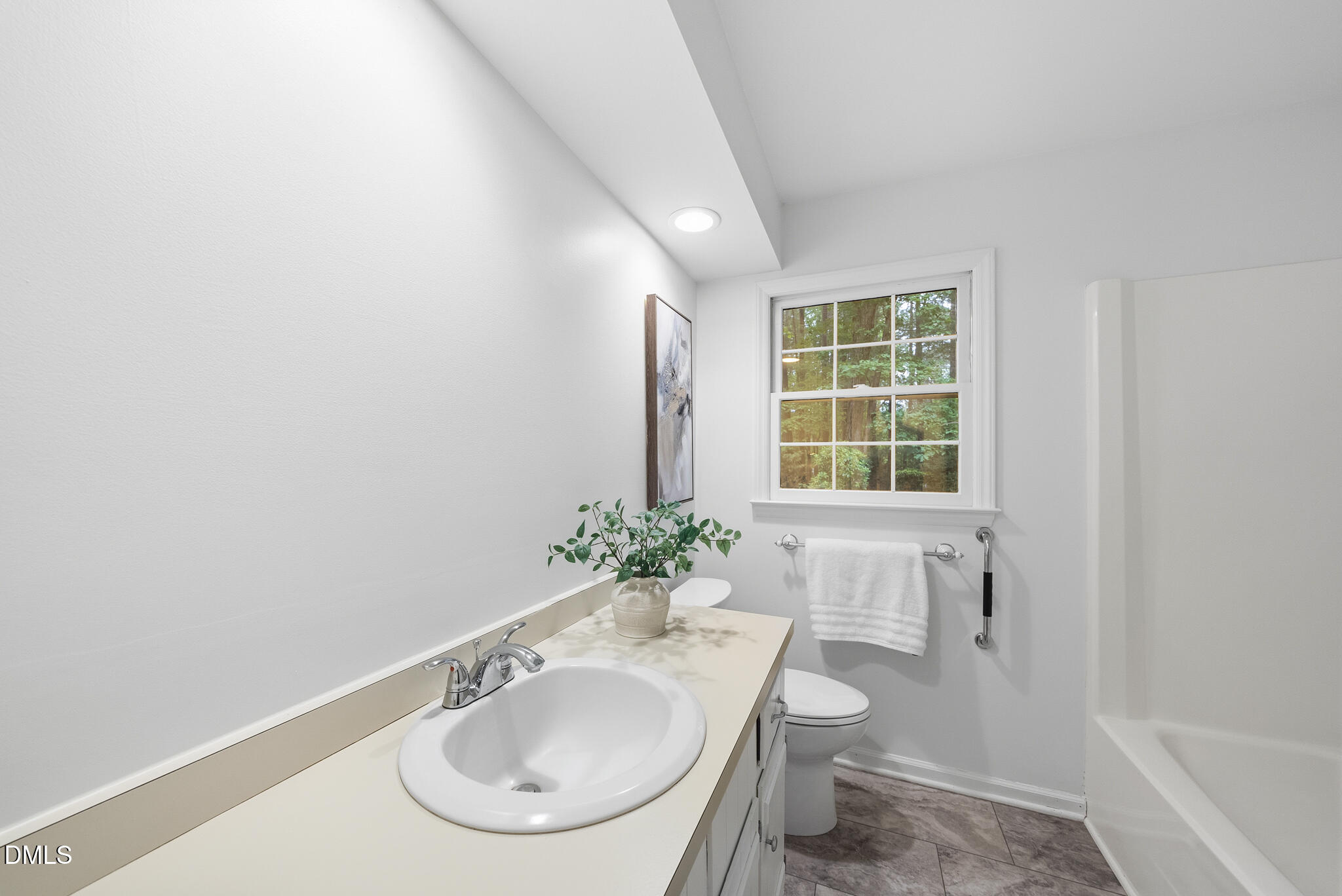 3404 Timberwood Court Raleigh, NC 27606 - Photo 23 of 45 a bathroom with a sink and a mirror
