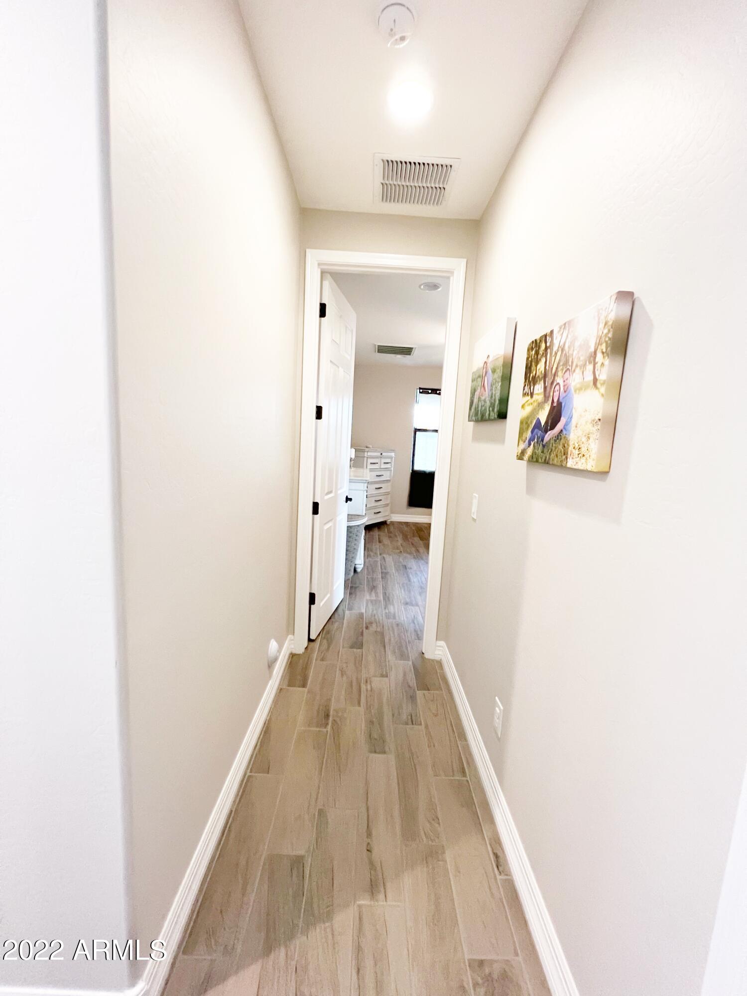 3330 West Fremont Rd. Phoenix, AZ 85041 - Photo 11 of 43 a view of a hallway with wooden floor