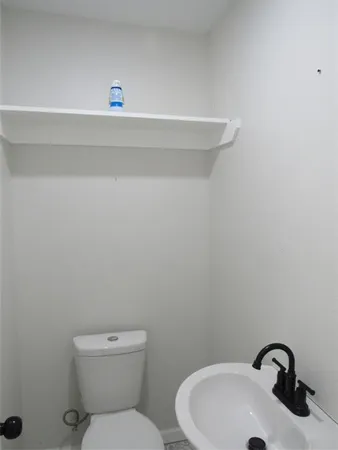 a bathroom with a toilet and a sink