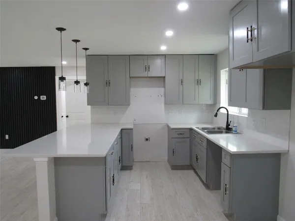 a kitchen with a sink stove and refrigerator