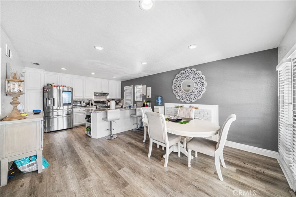 8526 San Vicente Avenue Riverside, CA 92504 - Photo 13 of 30 a view of a dining room with furniture and wooden floor