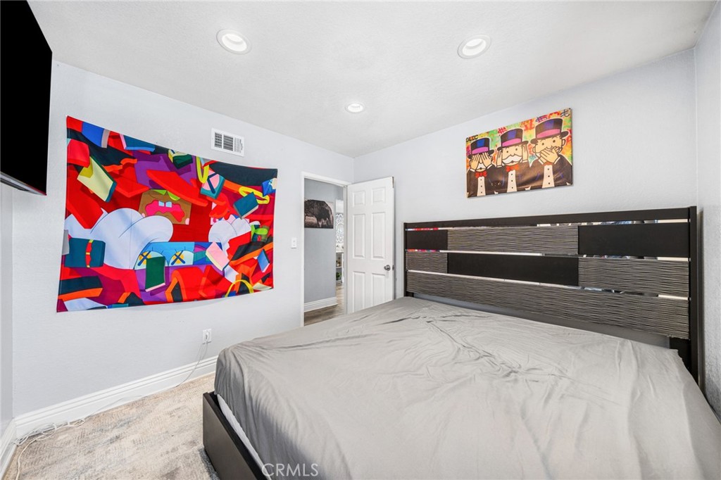 8526 San Vicente Avenue Riverside, CA 92504 - Photo 16 of 30 a bedroom with a bed and painting on the wall