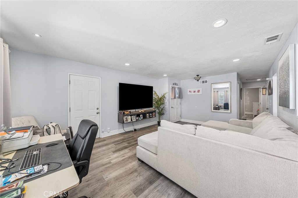 8526 San Vicente Avenue Riverside, CA 92504 - Photo 5 of 30 a living room with furniture and a flat screen tv