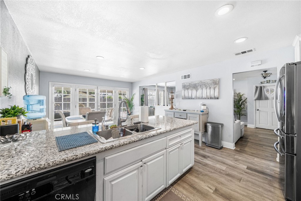 8526 San Vicente Avenue Riverside, CA 92504 - Photo 9 of 30 a kitchen with lot of counter space and wooden floor
