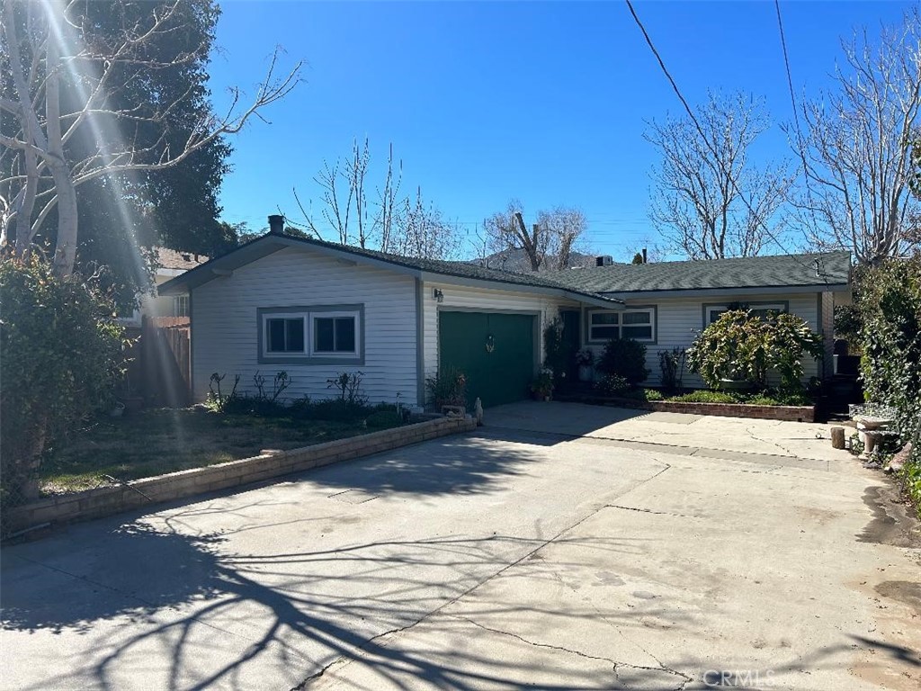 25035 De Wolfe Road Newhall, CA 91321 - Photo 1 of 1 a front view of a house with a yard