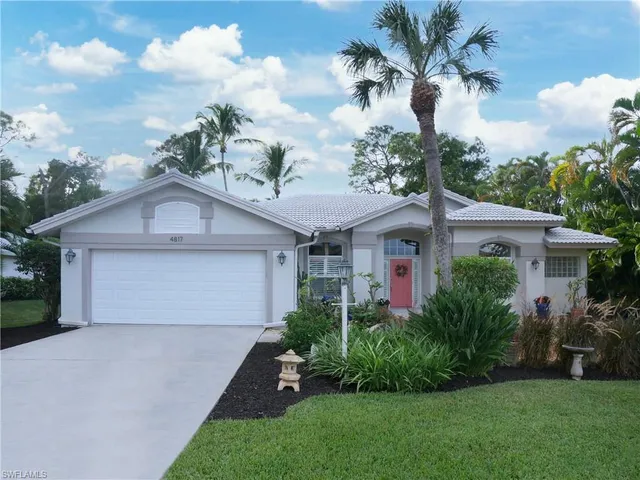 a front view of house with a garden