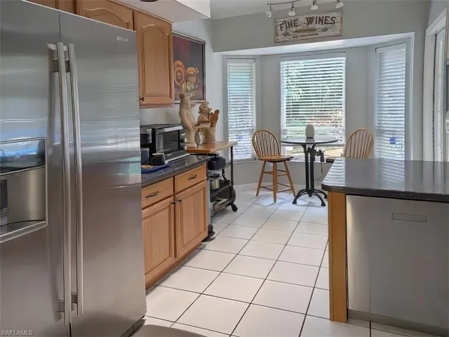 a kitchen with stainless steel appliances granite countertop a refrigerator sink and cabinets