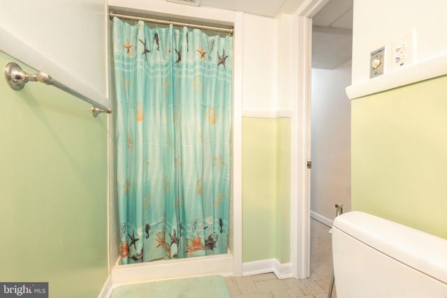 a bathroom with a shower and a toilet