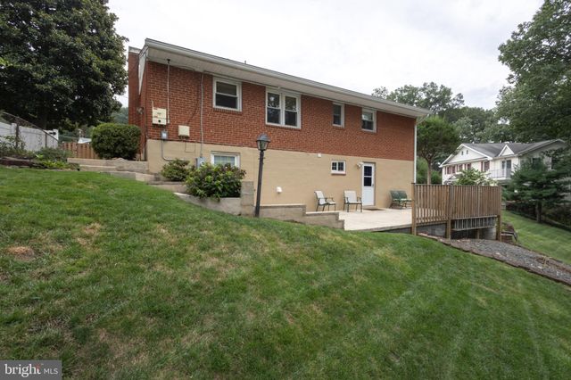 a backyard of a house with barbeque oven table and chairs