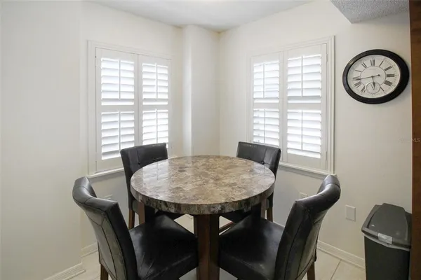 a view of a dining room with furniture and window