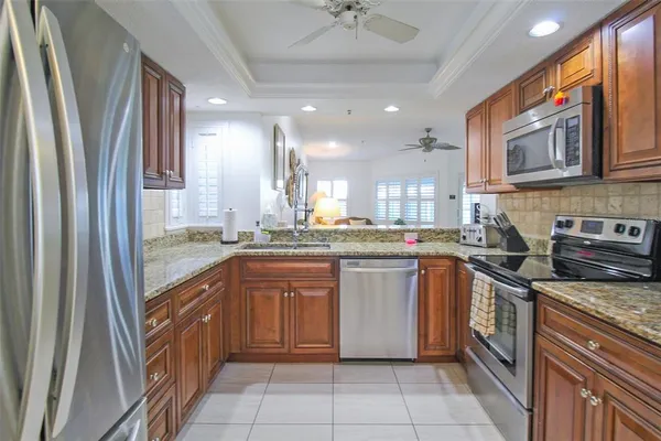 a kitchen with stainless steel appliances granite countertop a sink and a stove