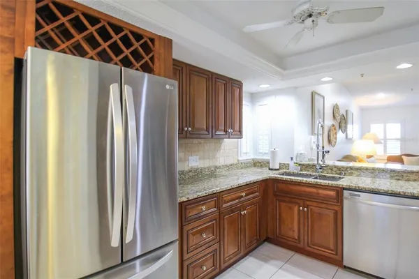 a kitchen with stainless steel appliances granite countertop a refrigerator and a sink