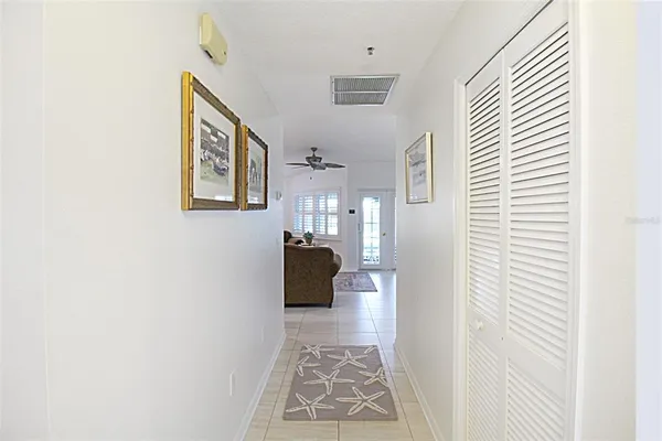 a view of a hallway with furniture