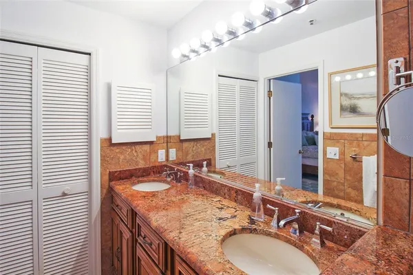 a bathroom with a granite countertop sink and a mirror