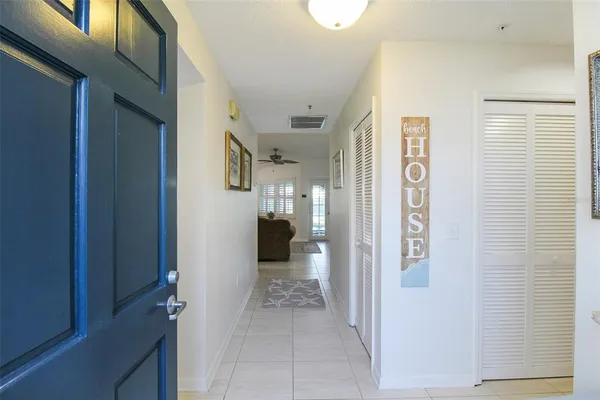 a view of a hallway with wooden shelves