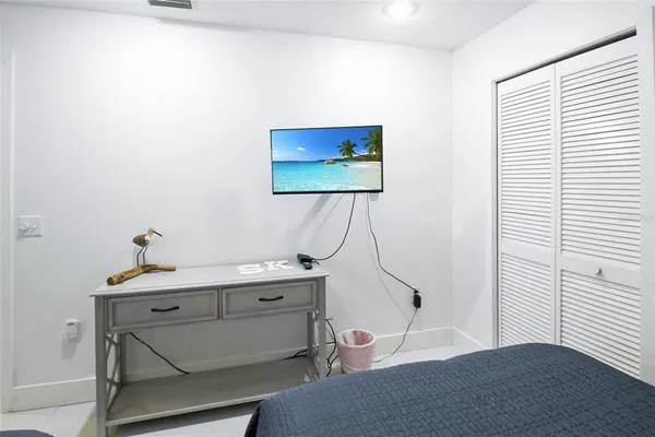 a room with a desk and a potted plant