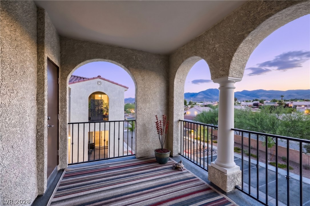 2555 Hampton Road, Unit 9301 Henderson, NV 89052 - Photo 7 of 36 Arched openings frame distant mountains from this inviting balcony, perfect for tranquil evenings.