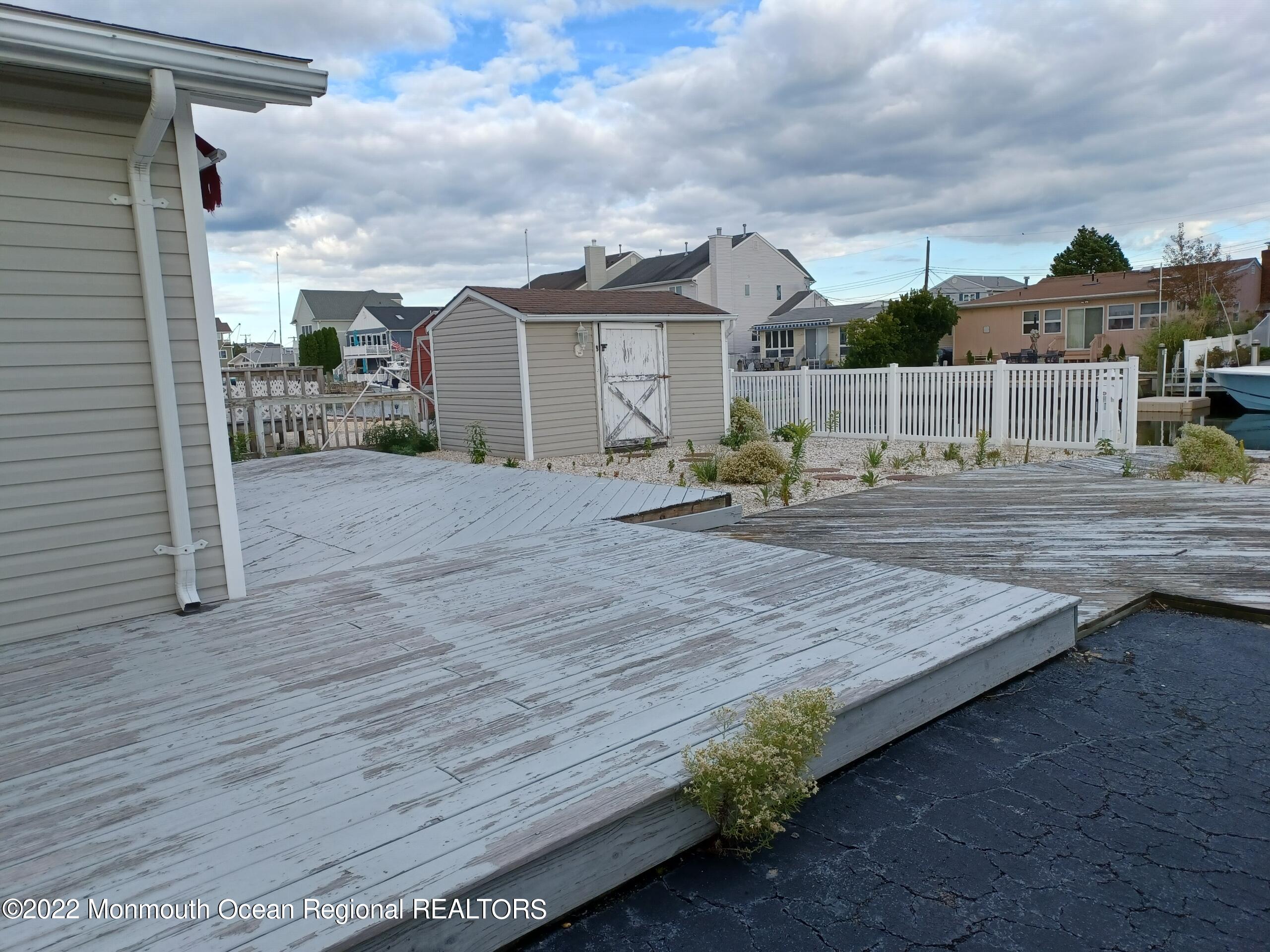 21 Commodore Drive Brick, NJ 08723 - Photo 11 of 13 a view of a dry yard with wooden fence