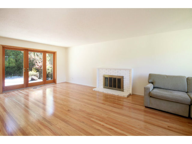 209 Segre Place Santa Cruz, CA 95060 - Photo 2 of 24 a view of an empty room with wooden floor and a fireplace