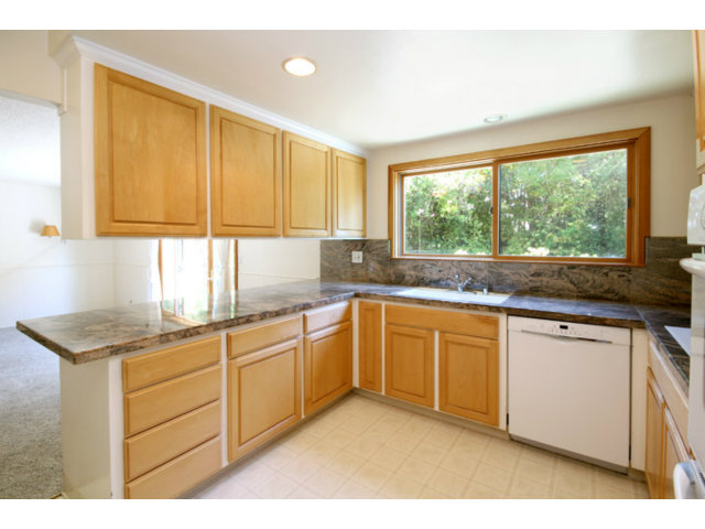 209 Segre Place Santa Cruz, CA 95060 - Photo 4 of 24 a kitchen with granite countertop cabinets stainless steel appliances a sink and a large window