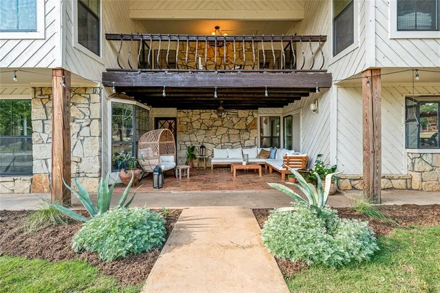 a living room with furniture a fireplace and a window
