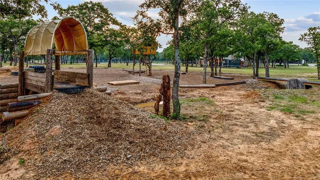 a living room with furniture a fireplace and a large window