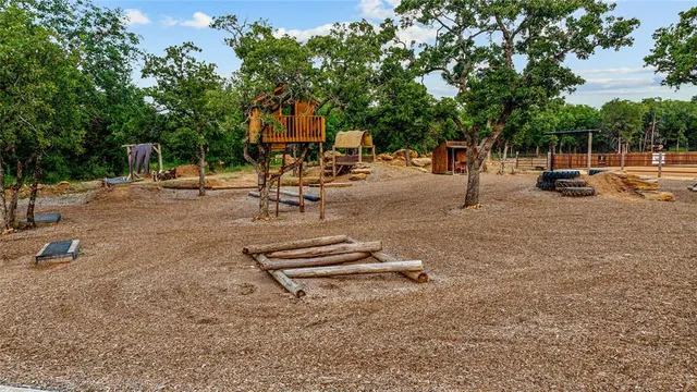 a view of a house with backyard and a tree