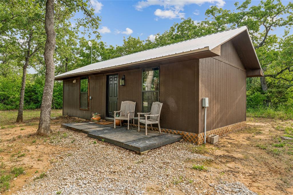 3113 Rock Creek Road Mineral Wells, TX 76067 - Photo 29 of 37 a view of a patio with a table chairs and backyard
