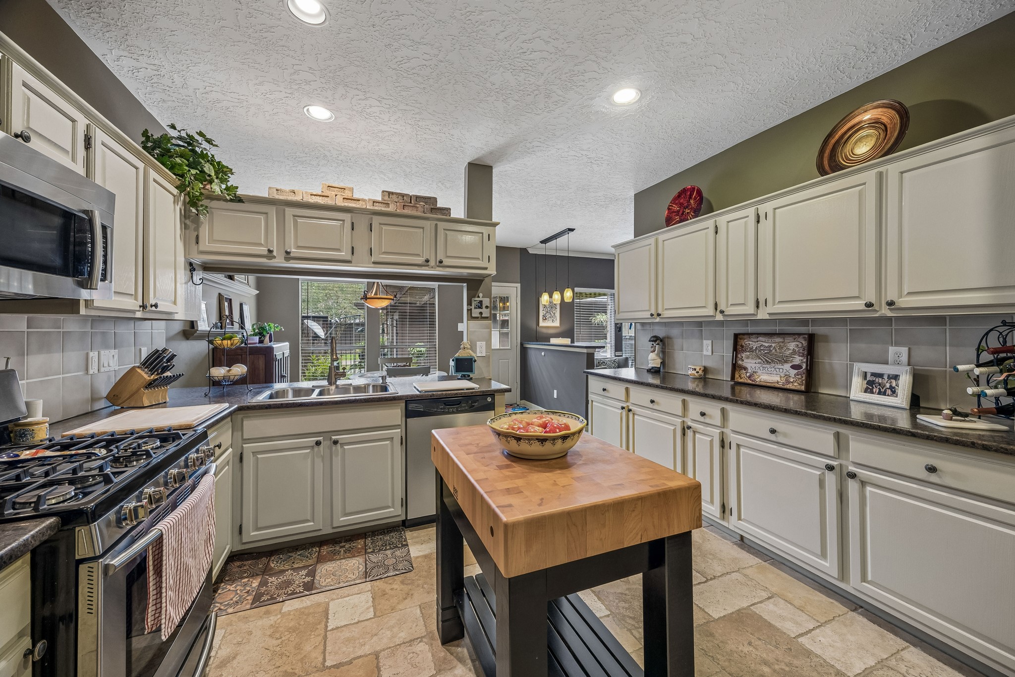 2030 Gemini Street Houston, TX 77058 - Photo 11 of 25 a kitchen with stainless steel appliances granite countertop a sink stove and refrigerator