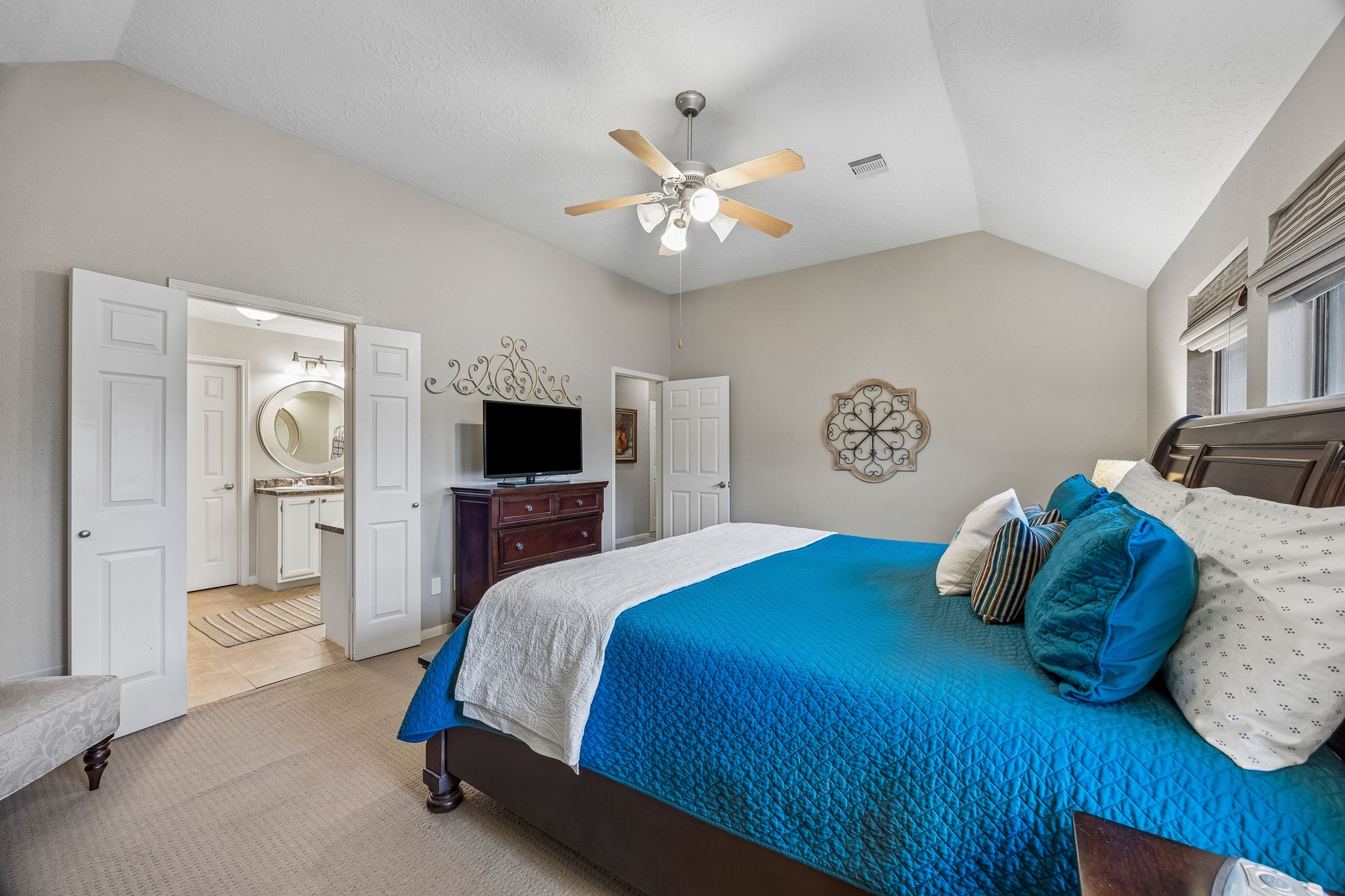 2030 Gemini Street Houston, TX 77058 - Photo 15 of 25 a bedroom with a bed and a chandelier