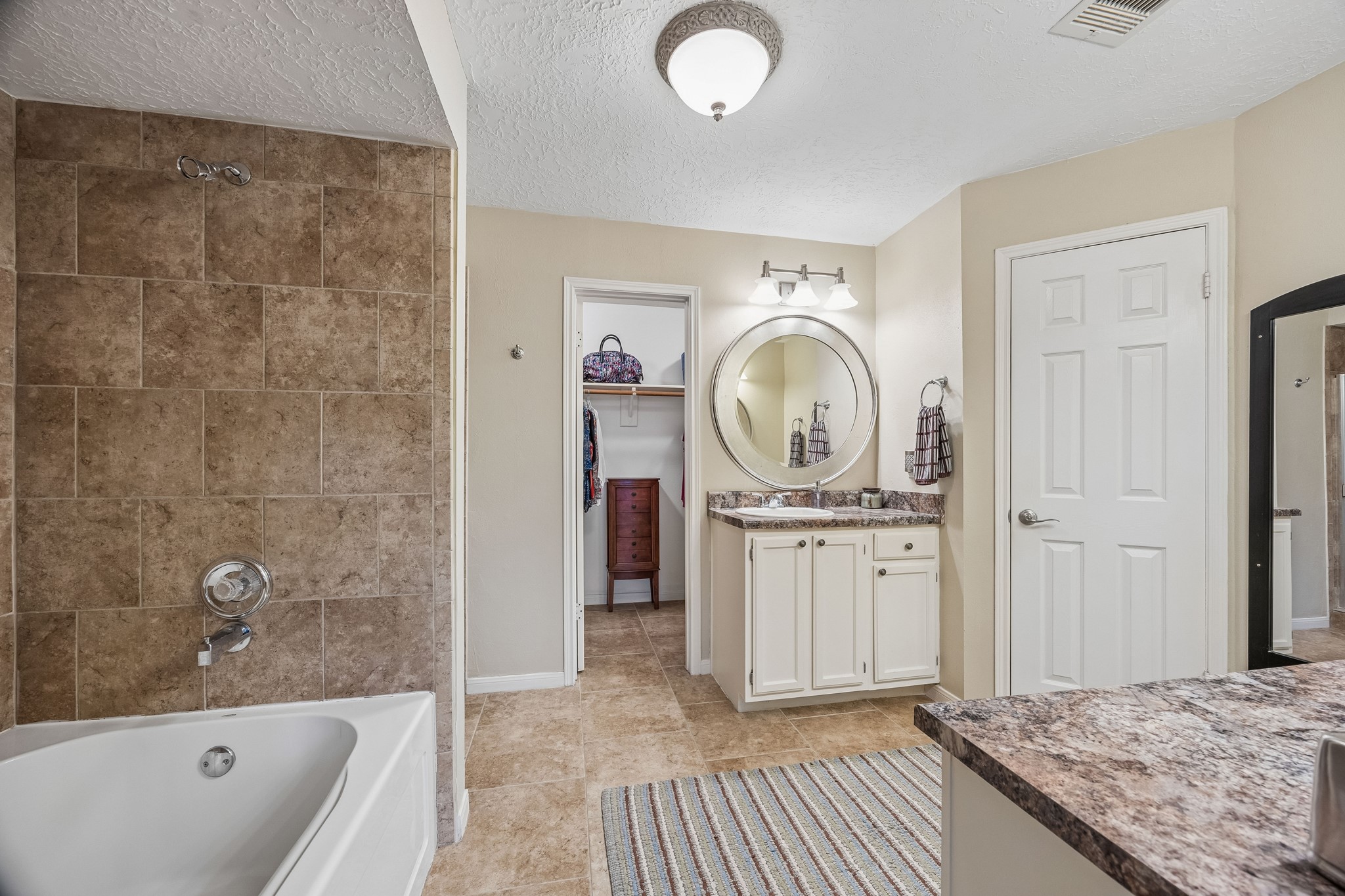 2030 Gemini Street Houston, TX 77058 - Photo 16 of 25 a spacious bathroom with a granite countertop tub sink and mirror