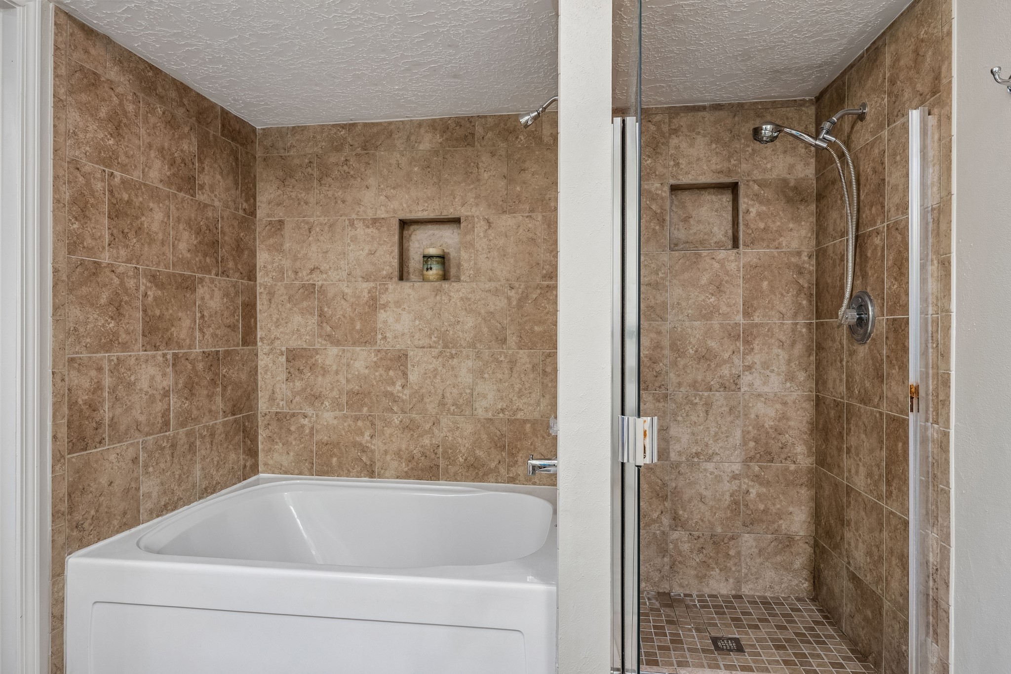 2030 Gemini Street Houston, TX 77058 - Photo 18 of 25 a bathroom with a bathtub and a shower