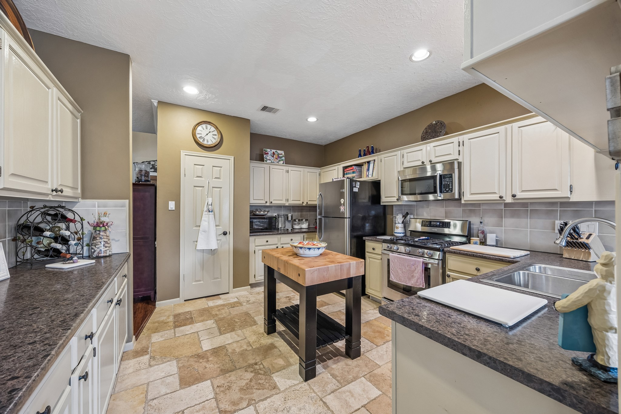 2030 Gemini Street Houston, TX 77058 - Photo 9 of 25 a kitchen with stainless steel appliances granite countertop a sink stove and refrigerator