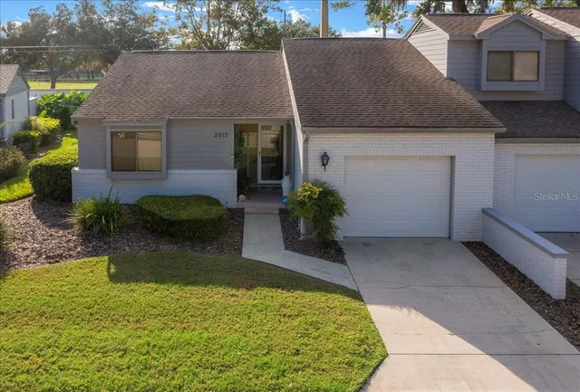 a aerial view of a house with a yard and a garage
