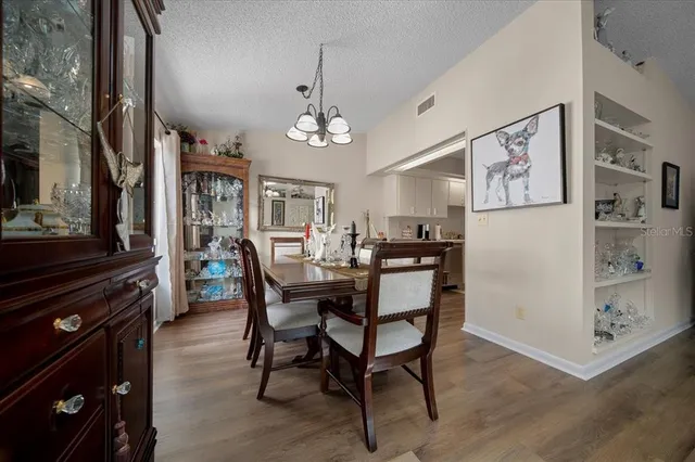 a kitchen with refrigerator and cabinets