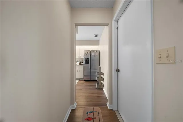 a kitchen with stainless steel appliances granite countertop a sink a stove and white cabinets