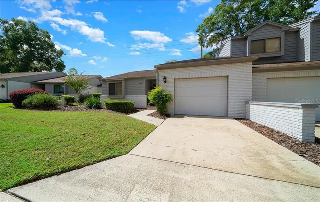 a view of a house with backyard and a garden