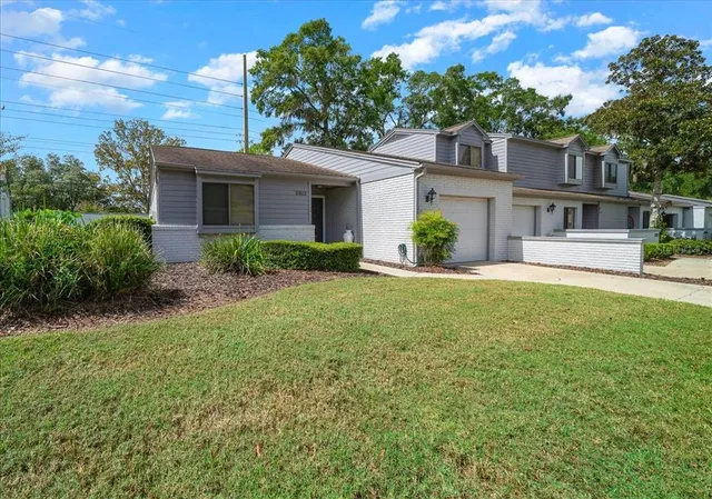 a view of a patio with table and chairs and wooden fence