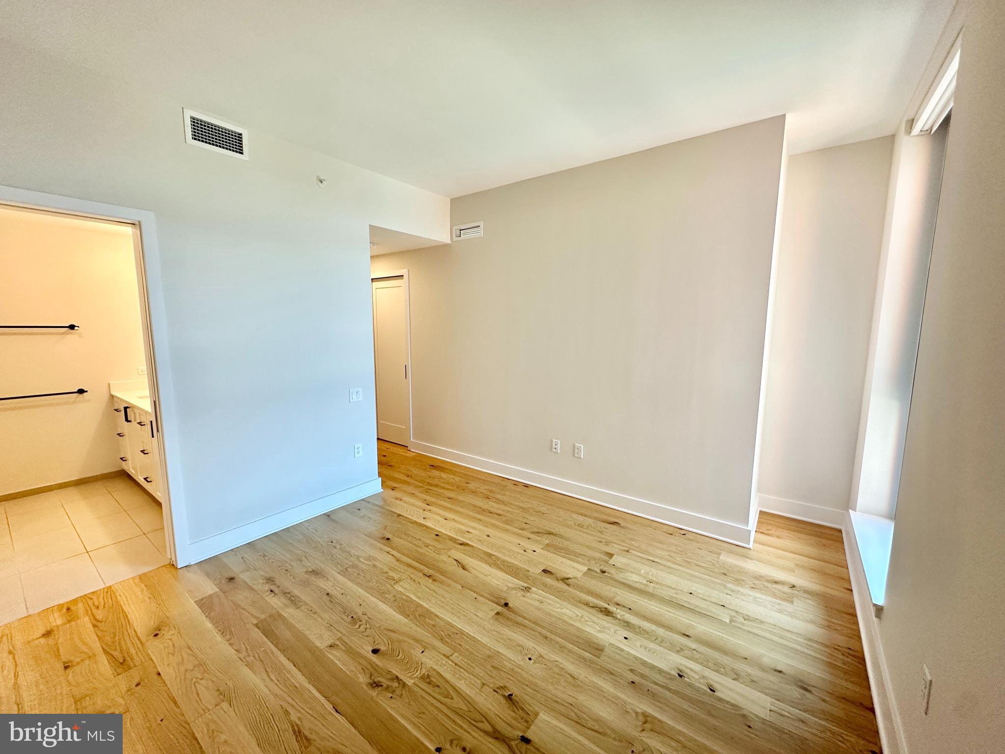 1211 Van Street Southeast, Unit 1201 Washington, DC 20003 - Photo 21 of 60 a view of an empty room with wooden floor