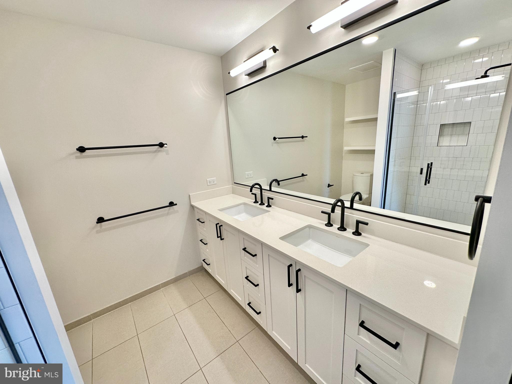 1211 Van Street Southeast, Unit 1201 Washington, DC 20003 - Photo 23 of 60 a bathroom with double vanity sink and mirror