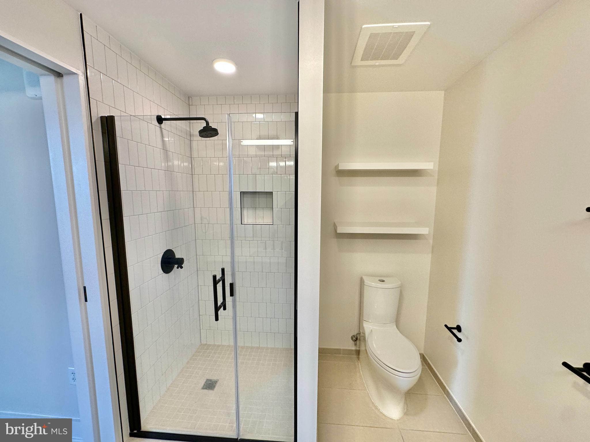 1211 Van Street Southeast, Unit 1201 Washington, DC 20003 - Photo 24 of 60 a bathroom with a shower and toilet